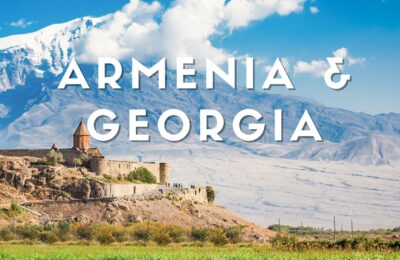 Paesaggio dell’Armenia con antichi villaggi e monasteri tra le colline verdi sotto un cielo azzurro.